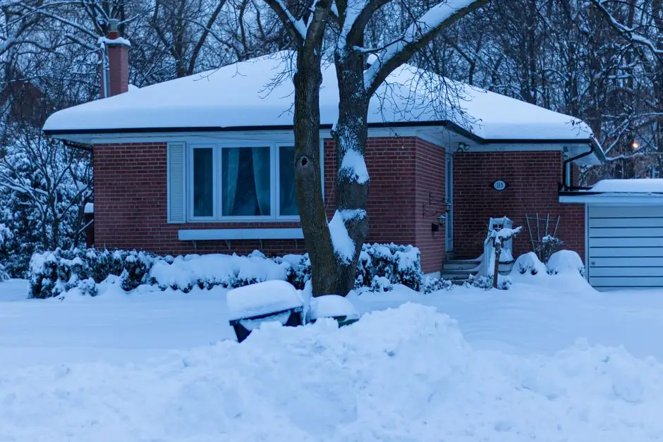 A serene winter morning scene of a snow-covered house in Toronto, Canada.